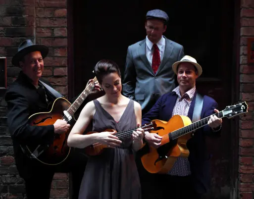 The Irwell Street String Band with Hetty Kate, Sam Lemann, Andy Baylor and Leigh Barker posed with ukulele and guitars in Melbourne